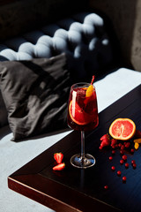 Glass of aperol spritz cocktail on wooden table in cafe