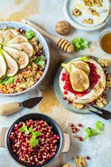 close-up view of tasty healthy couscous salat with figs fruits, nuts and pomegranate seeds