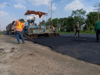 Fototapeta na wymiar Picture blurred asphalt road construction By using heavy machinery