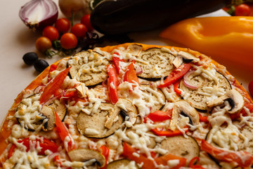 Hot italian pizza on a table with vegetables