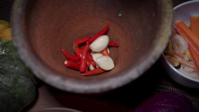 Slow Motion Clips,The chef is putting pepper and garlic in a mortar.