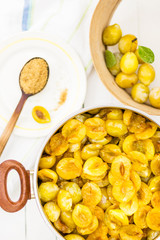 Sliced plums in a pot prepared for cooking jam, food and healthy eating concept