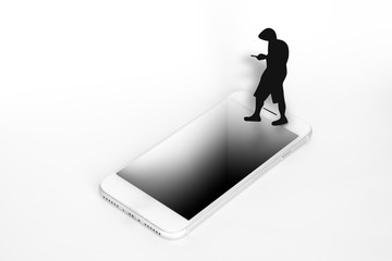 A man silhouette distracted looking at his phone and almost falling on a hole on a smartphone