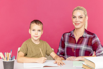 Mother with son at home doing homework together in quarantine time