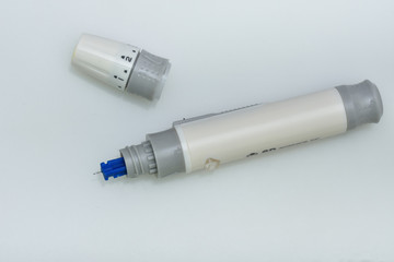 white  Lancet pen on white background. Diabetes concept