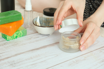DIY cosmetics. hands in the frame create a cream of different ingredients.