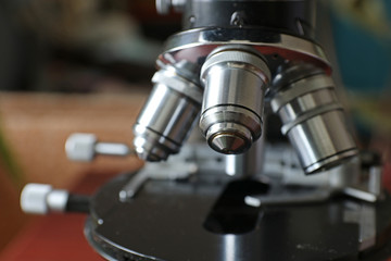 Fototapeta na wymiar Microscope with metal lenses in a research laboratory. Coronavirus vaccine development.