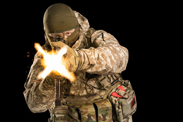 Soldier holding assault rifle and shooting. Uniform conforms to special services of the Russian...