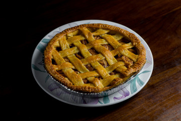 Delicious homemade pie with a crossing pattern on top of it