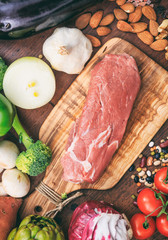 Raw pork fillet on wooden background. Fresh, healthy, uncooked pig meat on wood cutting board