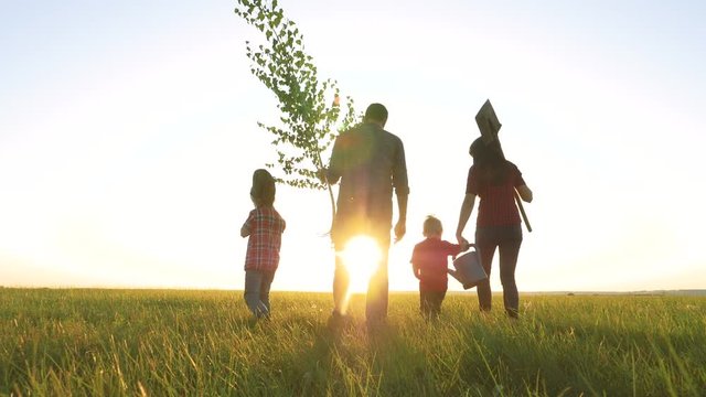 agriculture red neck farming happy family walking agriculture of farmers a silhouette concept slow motion video. mom dad son and daughter walk go lifestyle children happy family plant and water the