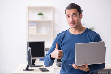 Young male it specialist working in the office