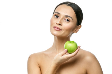 close-up portrait of a girl with clear skin holding a apple to her face, isolated on a white background
