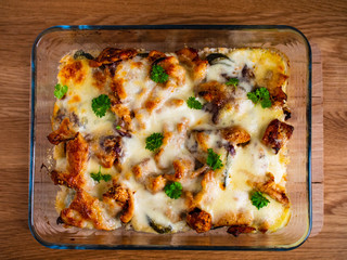 Rice casserole with barbecue chicken breast, cheese and vegetables
