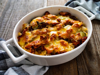 Rice casserole with barbecue chicken breast, cheese and vegetables
