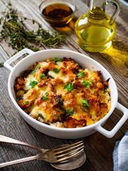 Rice casserole with barbecue chicken breast, cheese and vegetables

