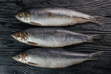 
fish on black wooden background