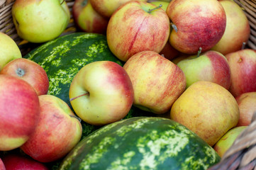 Fruit ( apples and watermelon )  in wicker basket