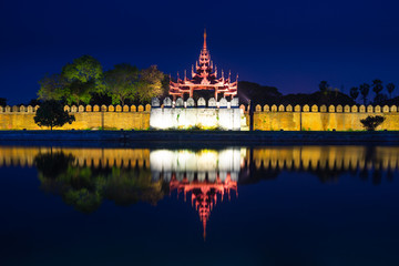 Fototapeta na wymiar Mandalay palace wall at night with reflection in Mandalay city, Myanmar