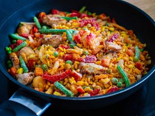 Paella chicken on wooden background
