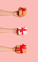Vertical collage with female hands holding wrapped gift boxes on pink background, closeup