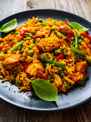 Paella chicken on wooden background 