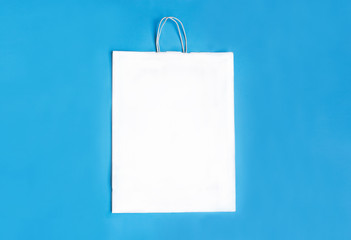 White paper package in the centre on a blue background. Space for text