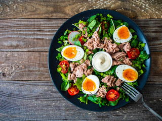 Fototapeta na wymiar Tuna salad on wooden table 