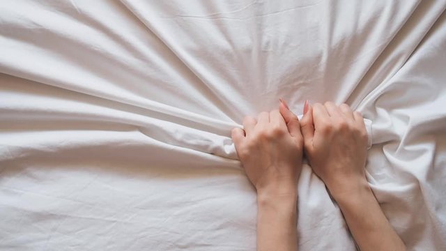 girlhands on the bed fit into the white sheet during sex