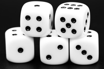 Macro closeup of five dice in front of dark background