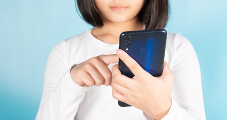 Asian children are holding mobile phones by searching for knowledge.