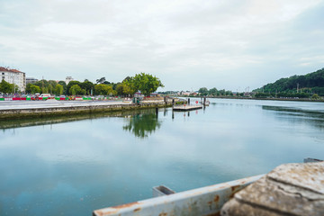 Fototapeta premium The city of Bayonne in France with buildings in the Nive River