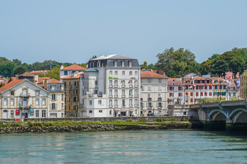 Fototapeta na wymiar The city of Bayonne in France with buildings in the Nive River