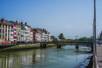 The city of Bayonne in France with buildings in the Nive River