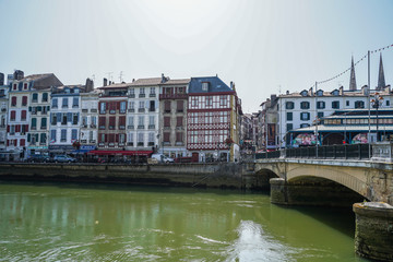 The city of Bayonne in France with buildings in the Nive River