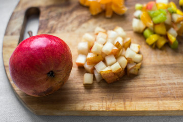 fruit salad serving ingredients slices cut on a wooden Board isolate on a white background kiwi nectarine pear Mandarin