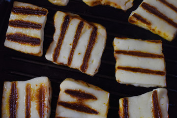 appetizing halumi cheese on a grill pan close-up.  fried cheese