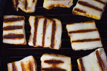 appetizing halumi cheese on a grill pan close-up.  fried cheese