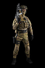 Soldier holding assault rifle. Uniform conforms to special services of the Russian Federation. Shot in studio. Isolated with clipping path on black background