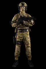 Soldier holding assault rifle. Uniform conforms to special services of the Russian Federation. Shot in studio. Isolated with clipping path on black background