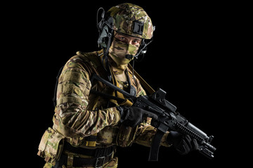 Soldier holding assault rifle. Uniform conforms to special services of the Russian Federation. Shot in studio. Isolated with clipping path on black background