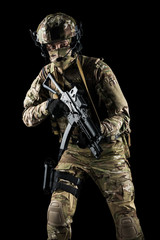 Fototapeta na wymiar Soldier holding assault rifle. Uniform conforms to special services of the Russian Federation. Shot in studio. Isolated with clipping path on black background