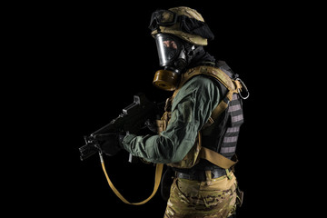 Soldier holding assault rifle. Uniform conforms to special services of the Russian Federation. Shot in studio. Isolated with clipping path on black background