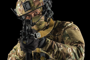 Soldier holding assault rifle. Uniform conforms to special services of the Russian Federation. Shot in studio. Isolated with clipping path on grey background