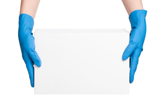 Female hands in rubber gloves holding cardboard box