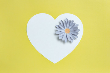 Heart shape card frame with grey color paper flower design on yellow background. Copy space, Valentine's day concept