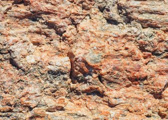 The rough surface of granite stone up-close.