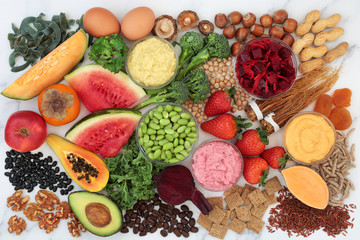 Health food for energy, vitality & fitness with fruit, vegetables, dips, nuts, dairy, pasta, legumes, cereals & herbal medicine. High in vitamins, minerals, antioxidants, protein & omega 3. Flat lay 