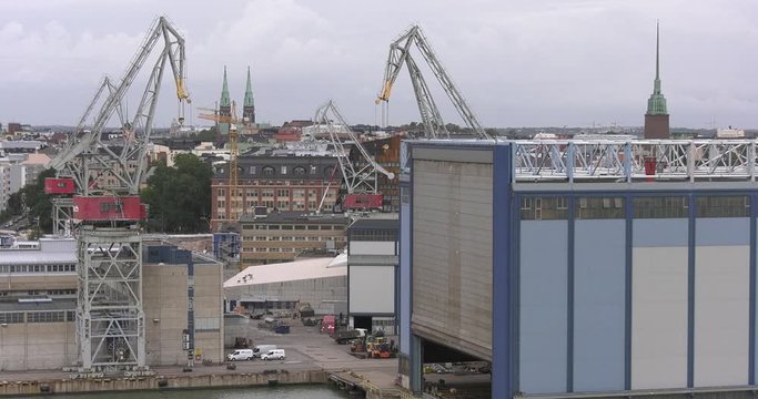4K Helsinki Baltic Sea Finnish Bay lagoon, buildings and port construction cranes cloudy summer day video in Jatkasaari district in Finland capital, northern Europe
