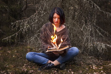 the book burns in the hands of a woman